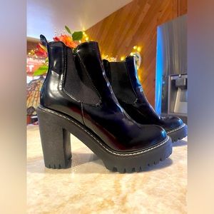 Black shiny rubber high heeled boots. thick but not too heavy.